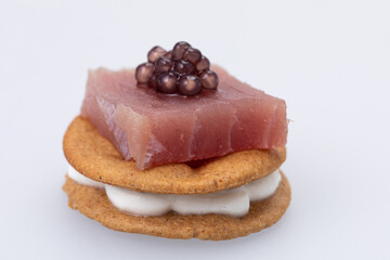Canape with tuna and caviar, isolated on white