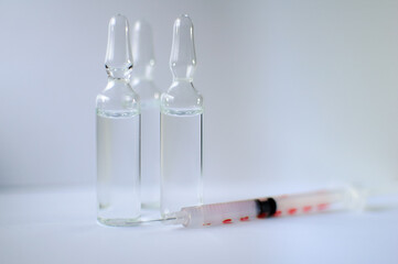 Medical ampoules and insulin syringe isolated on white background, vaccination concept