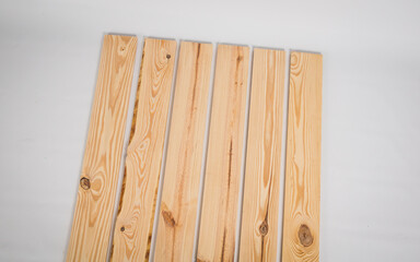 Unfinished raw pine lumber on a solid white background