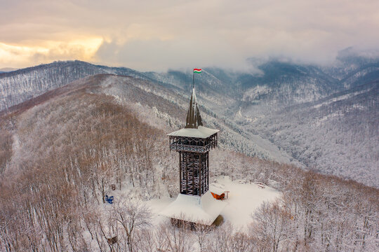 Aerial view of Millennium Lookout Tower which can be reach by foot from Szalajka-Valley near Szilv&aacute;sv&aacute;rad, Heves, Hungary. Winter landscape with cloudy sky.