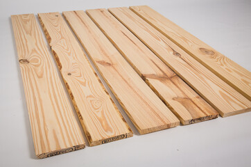 Unfinished raw pine lumber on a solid white background