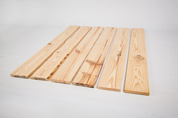 Unfinished raw pine lumber on a solid white background