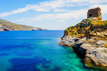 Fototapeta na wymiar On the island of Andros, in the Cyclades archipelago, in the heart of the Aegean Sea, the old Venetian castle, on the islet connected to the city by a stone bridge, protected the city
