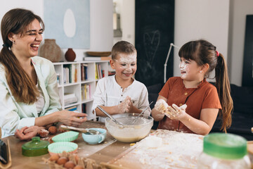 mother with her kids baking together in their home