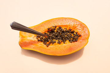 Ripe papaya half ready to be eaten with spoon or fork
