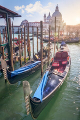 Fototapeta na wymiar Venetian gondola moored in a traditional canal of Venice, Italy.