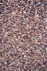 Decorative exterior coating of warm colored marble crumb close-up