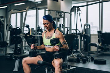 Naklejka na ściany i meble tattooed woman workout in gym