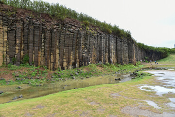 Terracotta columnar basalt columns on the tropical island of Penghu Taiwan. Geological lava plateau.