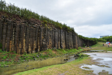 Fototapeta na wymiar Terracotta columnar basalt columns on the tropical island of Penghu Taiwan. Geological lava plateau.