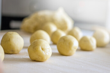 Fototapeta na wymiar Close-up of homemade raw dough cookies on a baking sheet, authentic home baker hobby