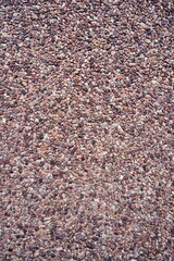 Decorative exterior coating of warm colored marble crumb close-up