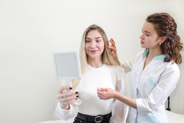 Doctor consulting the patient showing the condition of the scalp showing in the mirror