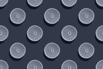 Seamless pattern of toned half of an orange isolated on a blue background, mock up, top view. Minimal, food texture, fruit background. Original toned fruit background.