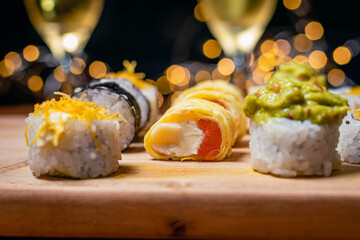close-up of sushi food on wooden base with dark background for valentine's day dinner with champagne glasses cordoba argentina