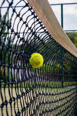 green tennis or paddle ball and court net with selected focus at high speed