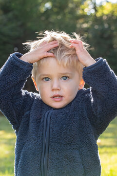 Little Boy In Blue Coat Has An Oh No Moment