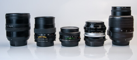 set of old and modern photo lens on white background with reflection