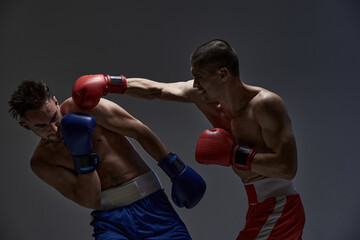 Plakat Jab of professional fighter, fighting guys in boxing gloves during mixed fight sparring, martial arts concept