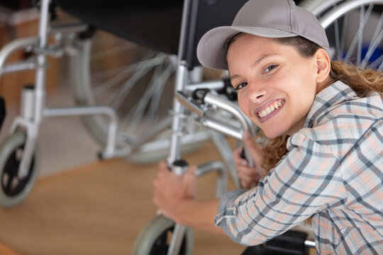 woman is repairing a wheelchair in workshop
