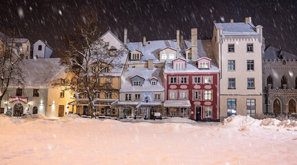 Beautiful winter night in Riga, Latvia. Winter wonderland with cosy houses at night.
