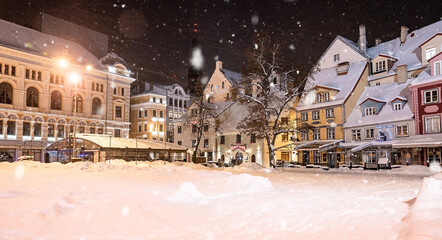 Beautiful winter night in Riga, Latvia. Winter wonderland with cosy houses at night.