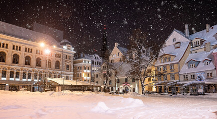 Beautiful winter night in Riga, Latvia. Winter wonderland with cosy houses at night.