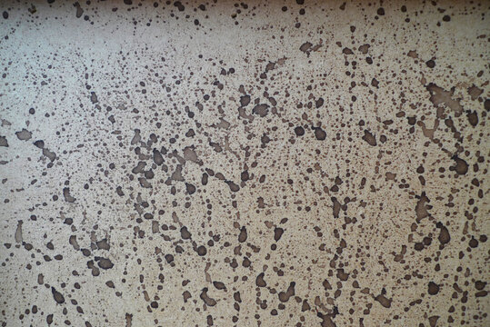 Bloated plywood splattered with brown ink 