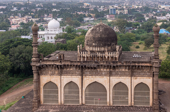 Vijayapura, Karnataka, India - November 8, 2013: Gol Gambaz Mausoleum. Adjacent stands the Majhid or mosque with its blackened dome and 2 minarets. White Hazrat Hashim Peer Dargah in back.