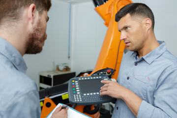 steel worker learning to use a machine