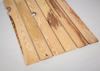 Unfinished raw pine lumber with light and dark color variation on a solid white background