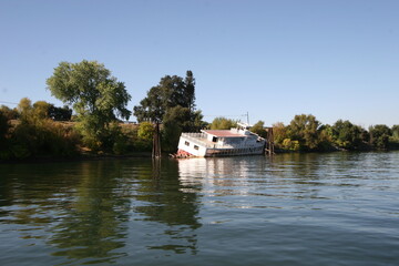 Fototapeta na wymiar Half sunken river Boat California Delta