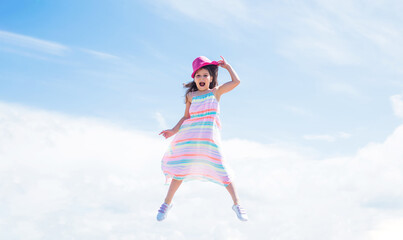 Obraz na płótnie Canvas spring season weather. summer fashionable look. freedom. beautiful teen girl jump in hat. kid fashion style. female natural beauty. happy childhood. cute child on sky background. Fashion is her life