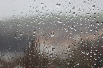 Dripping Raindrops on window on gloomy day