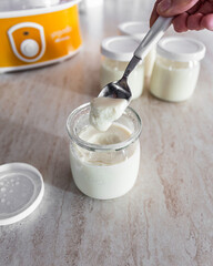 Teaspoon of homemade yogurt. Soy yogurt. Vegan recipe