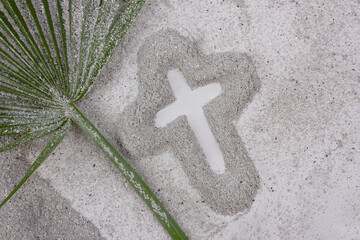 Ash Wednesday and Lent concept. Christian Cross drawing in ash with palm leaf. Christian religion...