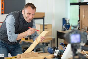 man making a diy blog recording in front of camera