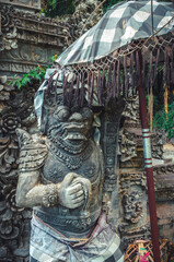 Traditional Balinese stone sculpture in Water Palace Tirta Gangga in Bali island, Indonesia