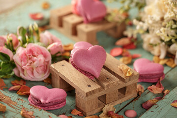 Heart shaped macarons on a wooden backgroun