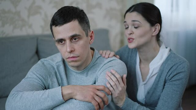 Wife calms her husband at home