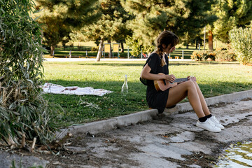 Woman playing her ukulele