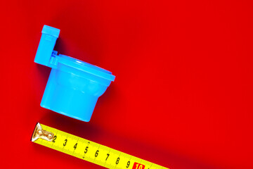 Toilet bowl on a  background.  tape-measures on the background. Measurement of the size.