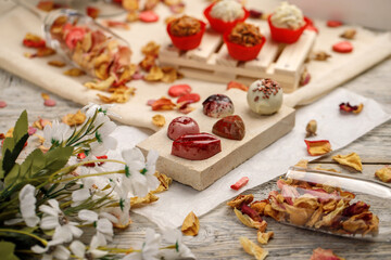 Handmade chocolates on a white wooden background