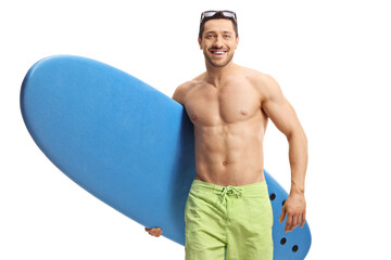 Young man walking towards the camera and carrying a surfboard - Powered by Adobe