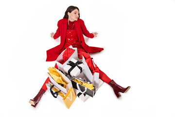 Woman sitting at the floor with different shopping bags