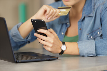 woman uses credit card to shopping online