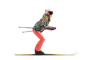 Full length profile shot of a female with a helmet skiing