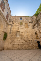 Ancient stone wall in Atrium near golden gate of diocletian palace in Split old town in Croatia