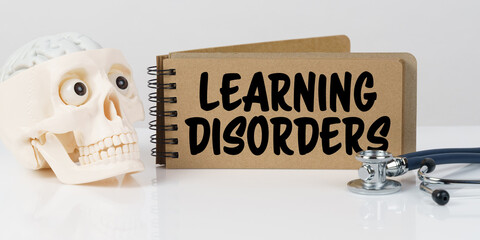 On the table lies a skull, a stethoscope and a notebook with the inscription - LEARNING DISORDERS