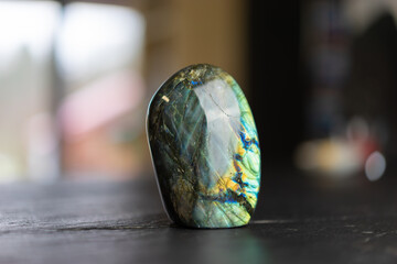 Labradorite mineral stone on slate worktop.